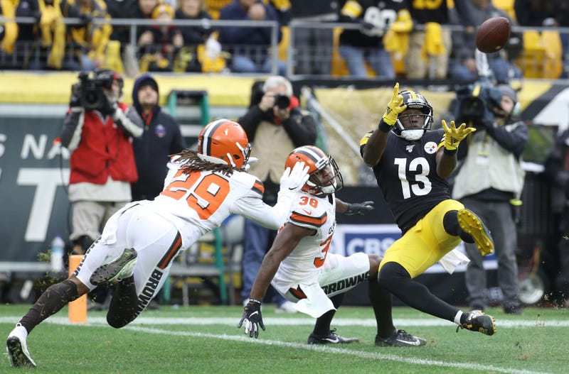 Dec 1, 2019; Pittsburgh, PA, USA; Pittsburgh Steelers wide receiver James Washington (13) catches a touchdown pass against Cleveland Browns defensive back T.J. Carrie (38) and defensive back Sheldrick Redwine (29) during the second quarter at Heinz Field.