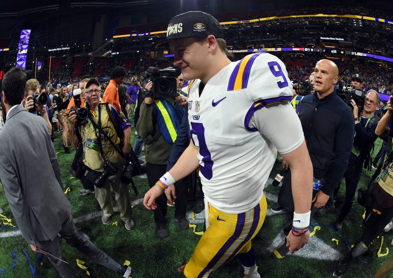 LSU Tigers quarterback Joe Burrow (9) walks across the field as they celebrate their 37-10 victory over the Georgia Bulldogs in the 2019 SEC Championship Game at Mercedes-Benz Stadium.