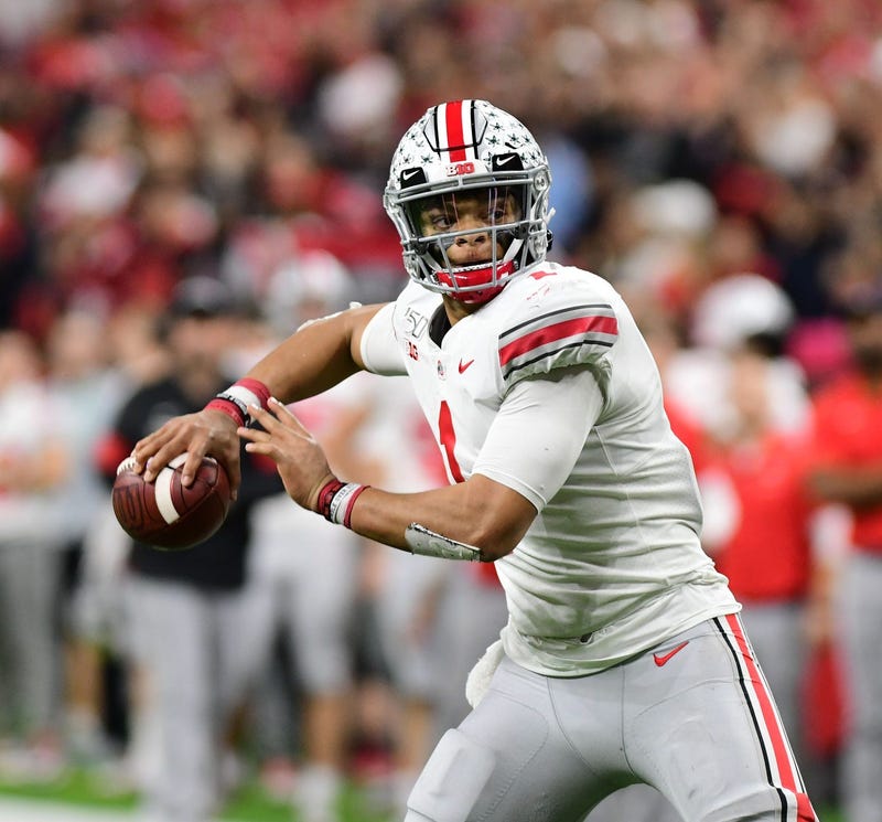 Ohio State quarterback Justin Fields (1) rolls out of the pocket to throw for a touchdown in the second half against the Wisconsin Badgers in the 2019 Big Ten Championship Game at Lucas Oil Stadium.