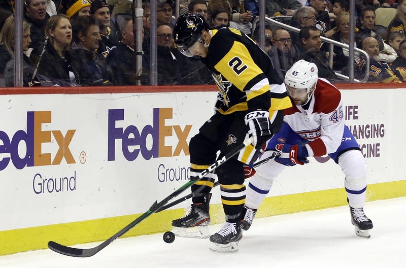 Pittsburgh Penguins defenseman Chad Ruhwedel (2) plays the puck in his skates against Montreal Canadiens right wing Riley Barber (45)