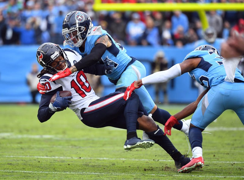 Houston Texans wide receiver DeAndre Hopkins (10) is tackled by Tennessee Titans strong safety Kenny Vaccaro (24) after a catch during the second half at Nissan Stadium.