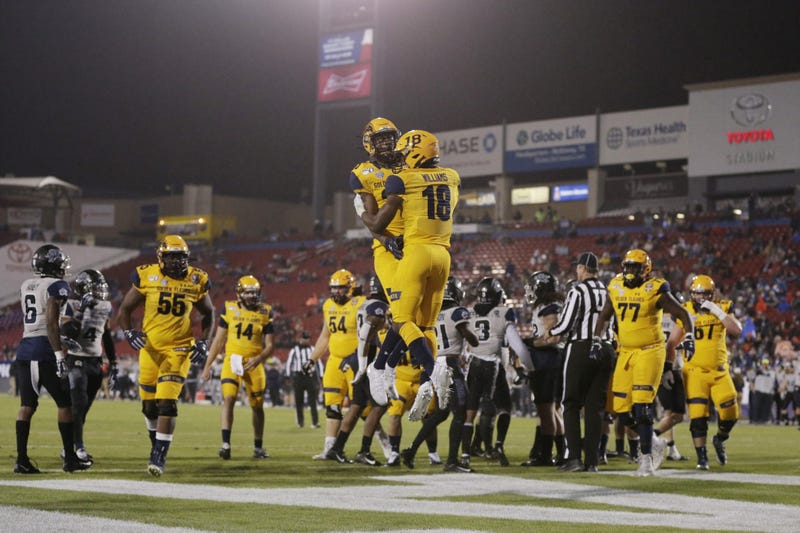 Kent State Golden Flashes running back Xavier Williams (18) and wide receiver Isaiah McKoy (23) celebrate a toouchdown in the first quarter against the Utah State Aggies during the Frisco Bowl at Toyota Stadium.
