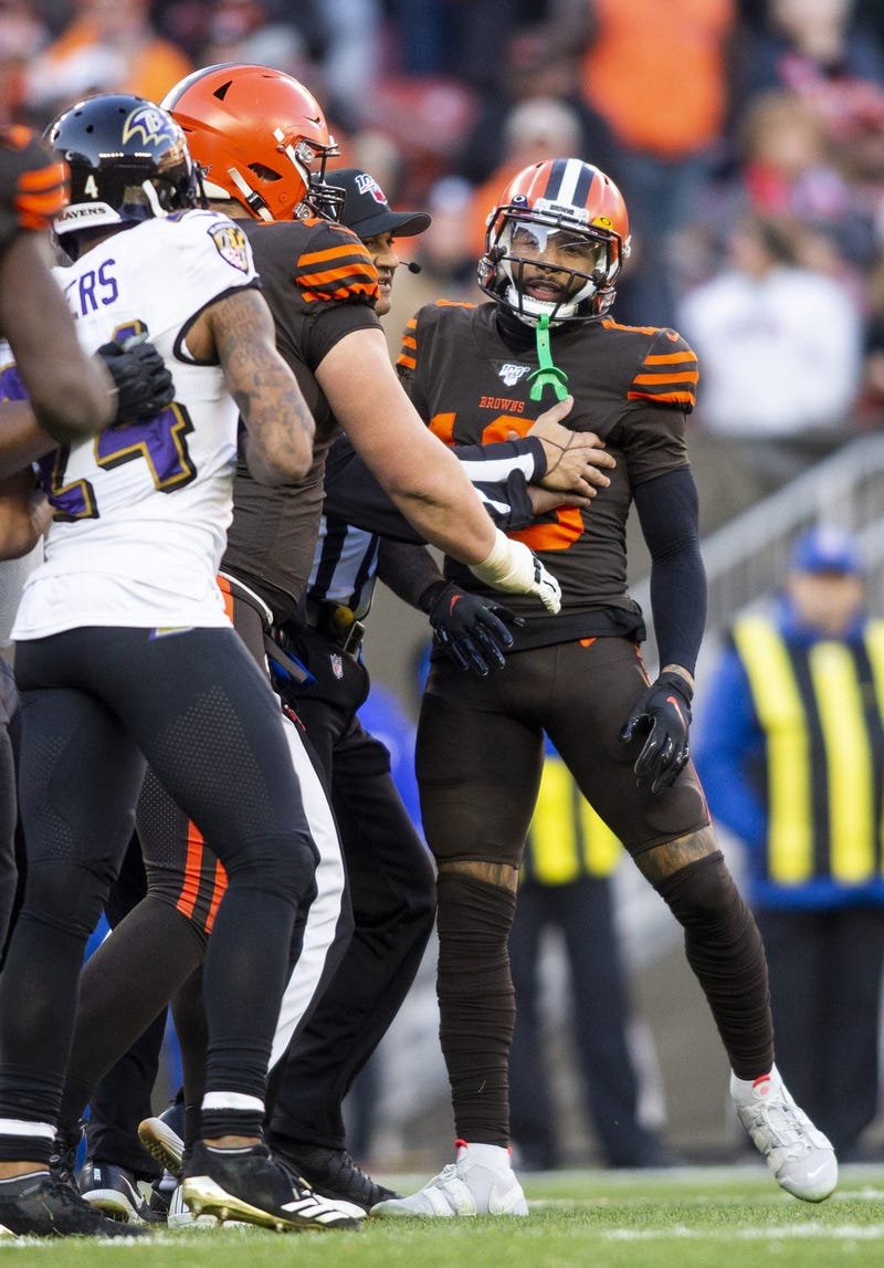 Cleveland Browns wide receiver Odell Beckham (13) is held back as he exchanges words with Baltimore Ravens cornerback Marcus Peters (24) during the fourth quarter at FirstEnergy Stadium.