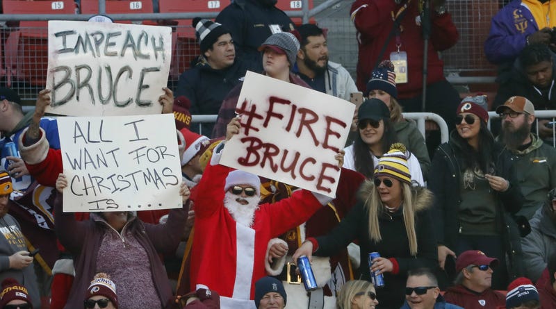Washington Redskins fans hold signs in the stands against Bruce Allen.