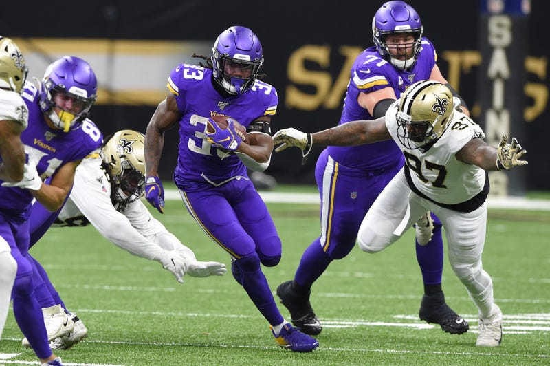 Jan 5, 2020; New Orleans, Louisiana, USA; Minnesota Vikings running back Dalvin Cook (33) runs the ball against New Orleans Saints defensive end Mario Edwards (97) during the first quarter of a NFC Wild Card playoff football game at the Mercedes-Benz Supe