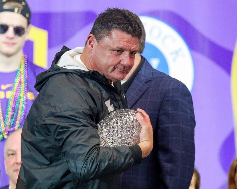 LSU Tigers head coach Ed Orgeron holds the AFCA Coaches' Trophy presented by Amway during the LSU championship trophy presentation at Pete Maravich Assembly Center. Stephen Lew-USA TODAY Sports