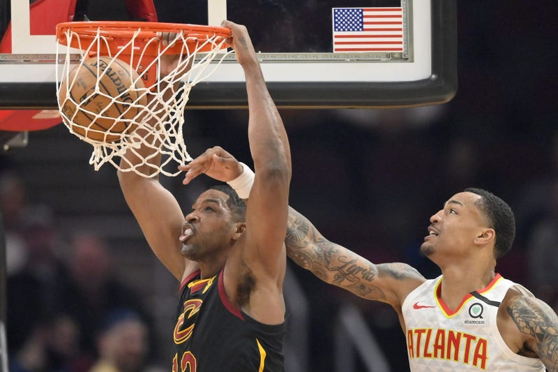Feb 12, 2020; Cleveland, Ohio, USA; Cleveland Cavaliers center Tristan Thompson (13) dunks beside Atlanta Hawks forward John Collins (20) in the second quarter at Rocket Mortgage FieldHouse. Mandatory Credit: David Richard-USA TODAY Sports