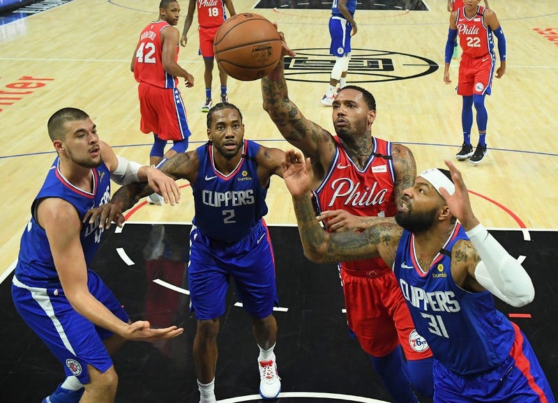 Los Angeles Clippers center Ivica Zubac (40) forward Kawhi Leonard (2), and Marcus Morris Sr. (31) and Philadelphia 76ers forward Mike Scott (1) reach for a rebound in the second half of the game at Staples Center.