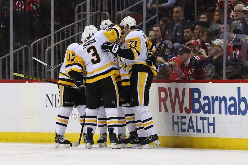 The Pittsburgh Penguins celebrate after a goal by defenseman Justin Schultz (4) against the New Jersey Devils during the second period at Prudential Center.