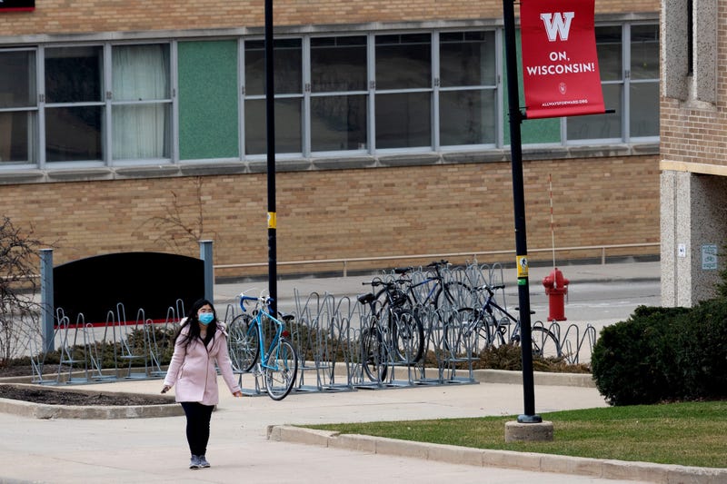 A UW-Madison student walks on an empty campus