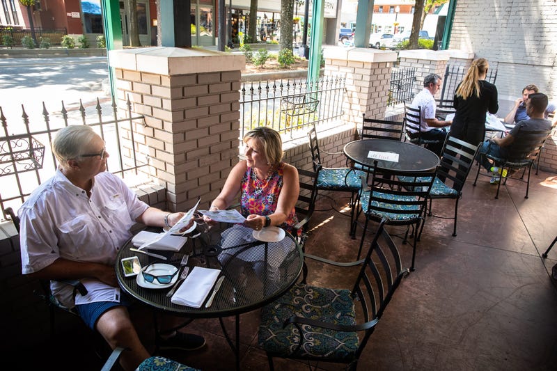 Vickie and Jeff Fuller, of Greenville, celebrate Jeff Fuller's 65th birthday at Pomegranate on Main Monday, May 4, 2020, the first day that restaurants downtown began to reopen outdoor seating since Gov. Henry McMaster banned on-premises dining in March