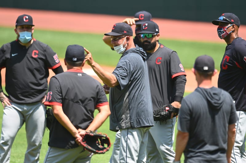 Cleveland Indians manager Terry Francona (middle, mask on chin)