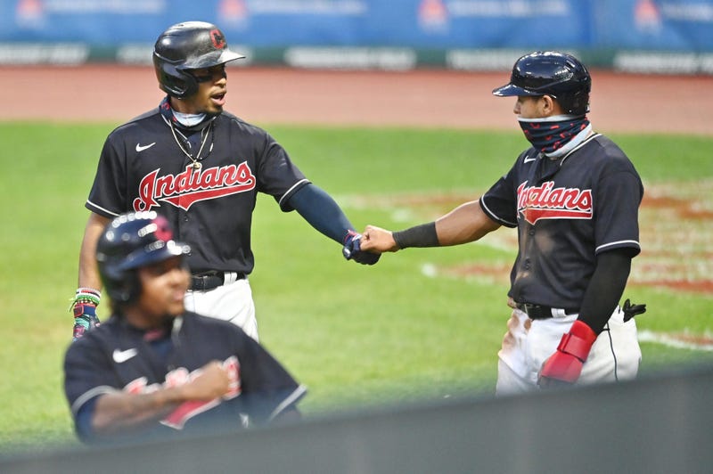 Cleveland Indians shortstop Francisco Lindor (12) celebrates with second baseman Cesar Hernandez (7) after hitting a three-run home run during the fifth inning against the Pittsburgh Pirates at Progressive Field.
