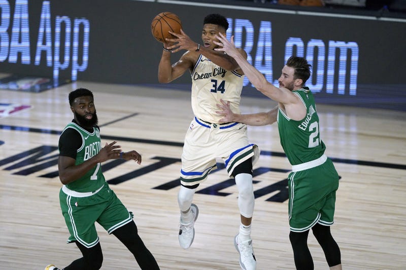 Giannis drives over a couple Celtics players
