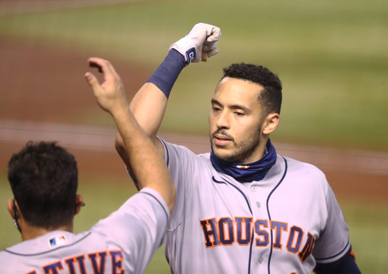 Houston Astros shortstop Carlos Correa celebrates with teammate Jose Altuve after hitting a solo home run in the second inning against the Arizona Diamondbacks at Chase Field.