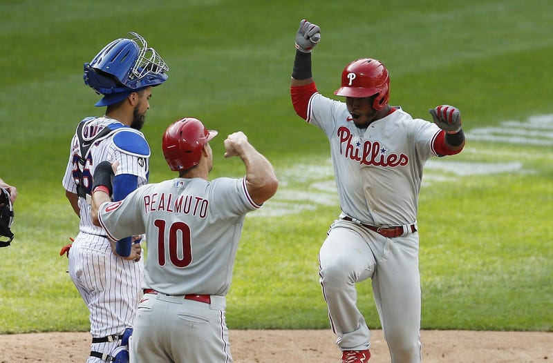 Philadelphia Phillies second baseman Jean Segura (2) reacts with Philadelphia Phillies catcher J.T. Realmuto (10) after hitting the game-winning two-run home run as New York Mets catcher Robinson Chirinos (26) looks away.