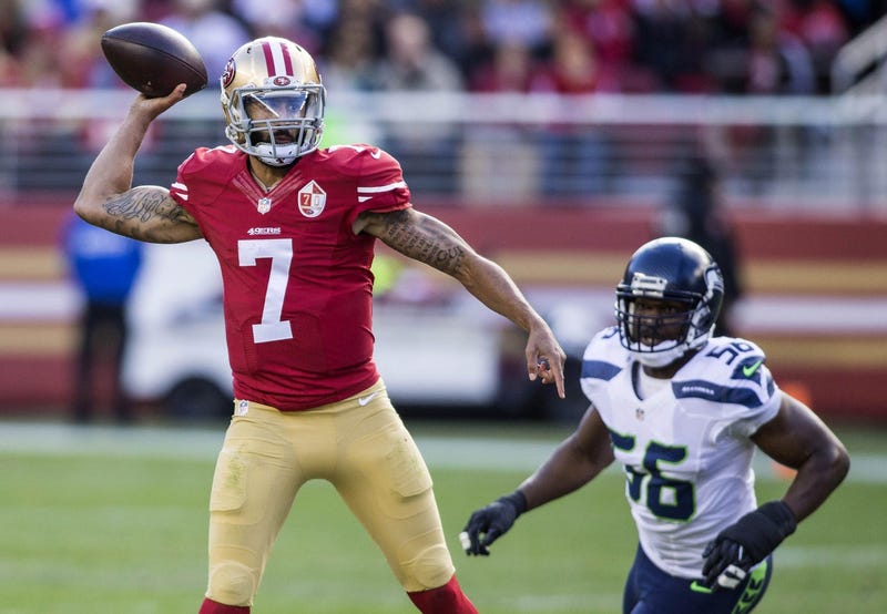 San Francisco 49ers quarterback Colin Kaepernick (7) passes the football while being rushed by Seattle Seahawks defensive end Cliff Avril (56) during the first quarter at Levis Stadium.
