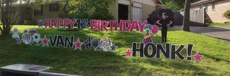 12-year-old Van poses in his front yard as neighbors honk to celebrate his birthday.