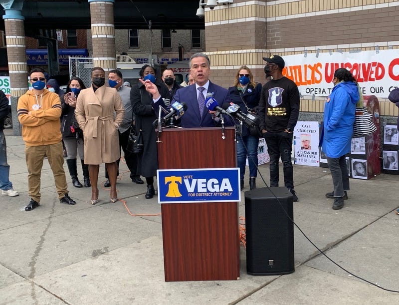 District Attorney candidate Carlos Vega (center) speaks to voters and press at an event in Kensington.