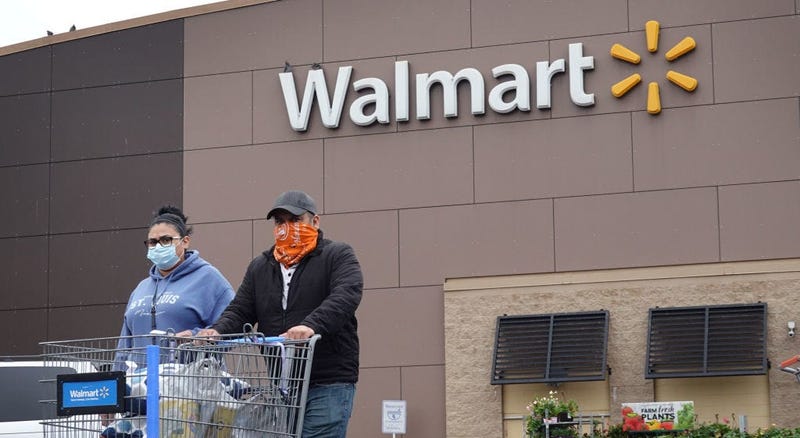 Shoppers wearing face coverings leaving a Walmart store.