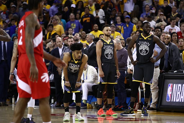 Warriors players look on at the end of Game of the 2019 NBA Finals.