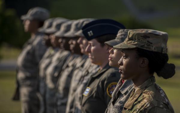 Air Force women at Kadena Air Base stand at attention during womens history month ceremony