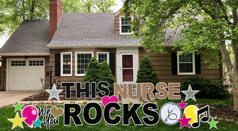 A large yard greeting sign in front of a house in KC