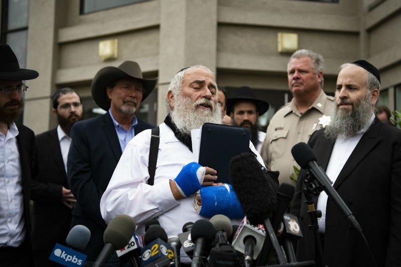 Rabbi Yisroel Goldstein speaks during a press conference in front of Chabad of Poway synagogue.