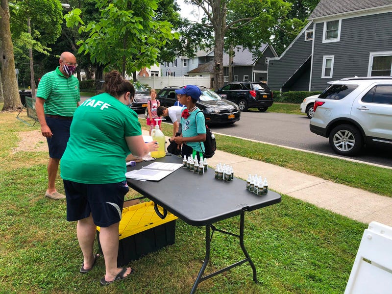 Kids sanitize their hands and undergo a temperature check before beginning summer youth camp in the Village of Hamburg. July 6, 2020 (WBEN Photo/Mike Baggerman)