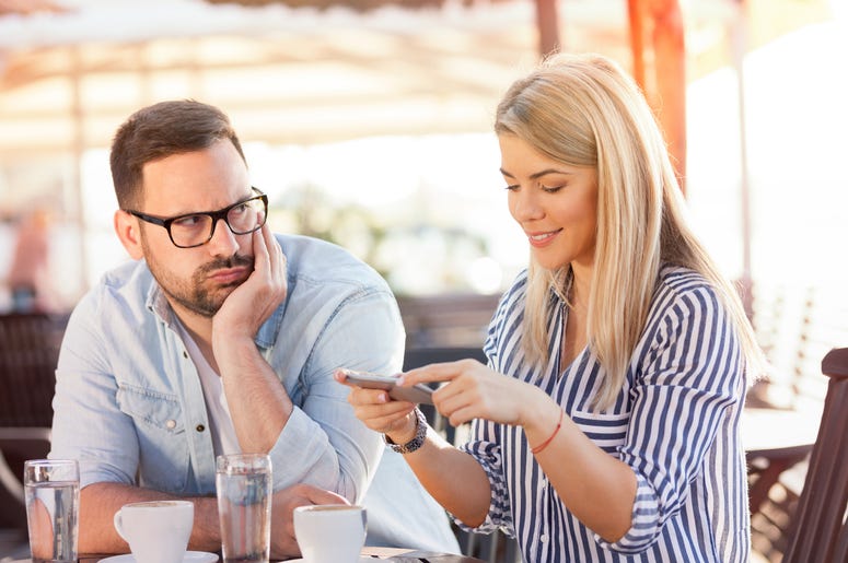 Man looking at woman using dating app