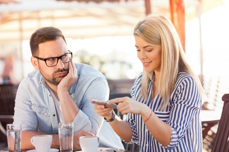 Man looking at woman using dating app