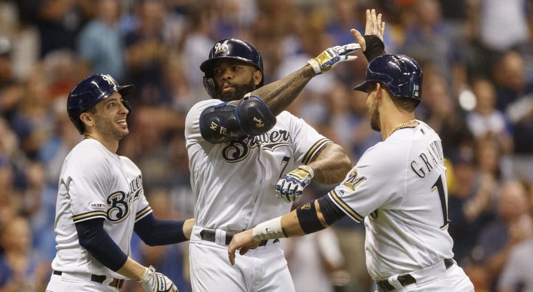 Eric Thames high fives his teammates