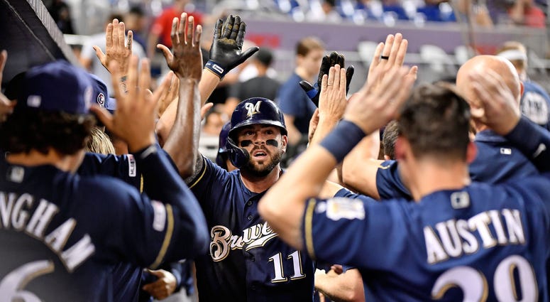 Mike Moustakas high fives his teammates