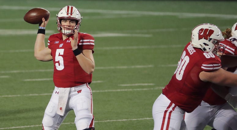 Wisconsin quarterback Graham Mertz looks and completes one of his 20 completed passes Friday night. Mertz only threw one incompletion and threw four of his five touchdowns in the first half in Wisconsin's opening victory over Illinois, Uwgrid24 18