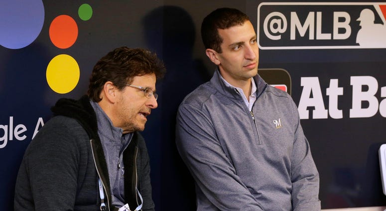 Brewers' GM David Stearns and owner Mark Attanasio chat in the dugout