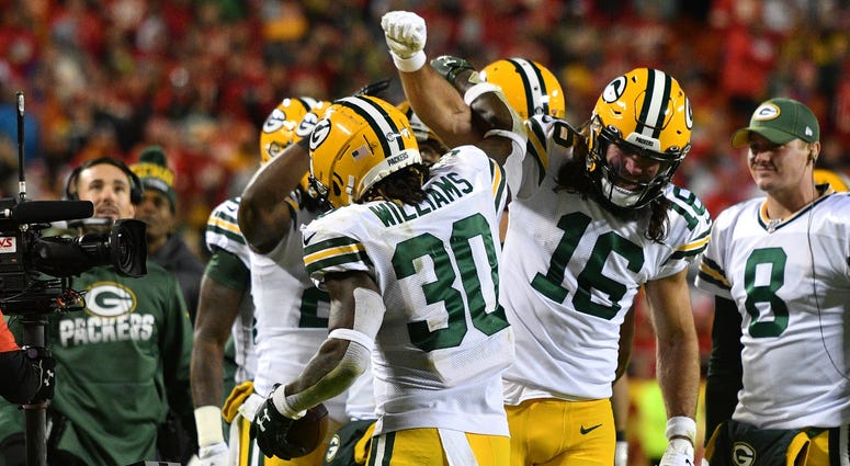 Oct 27, 2019; Kansas City, MO, USA; Green Bay Packers running back Jamaal Williams (30) celebrates with wide receiver Jake Kumerow (16) after scoring during the second half against the Kansas City Chiefs at Arrowhead Stadium. Mandatory Credit: Denny Medle