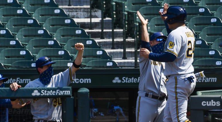 Avisail Garcia gives a high five after scoring a run