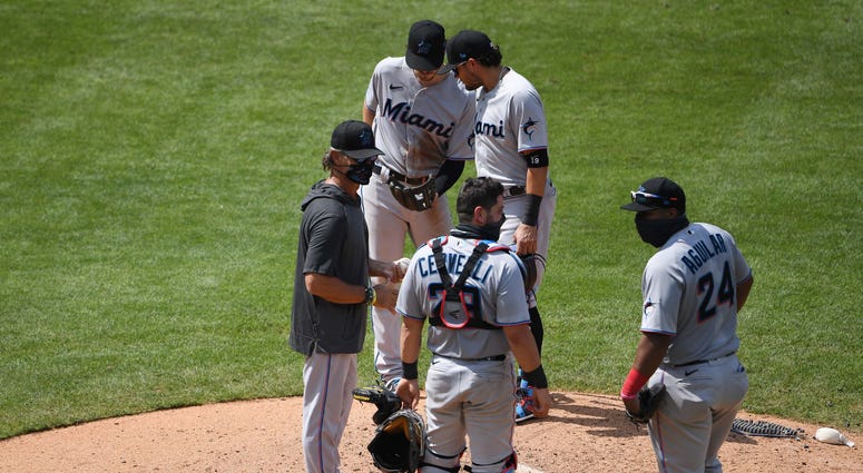 Members of the Marlins gather at the mound