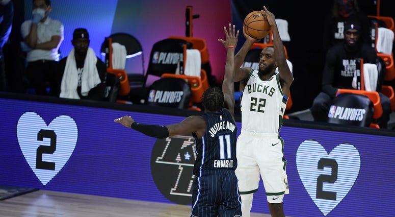 Bucks forward Khris Middleton rises up for a jumper against Orlando