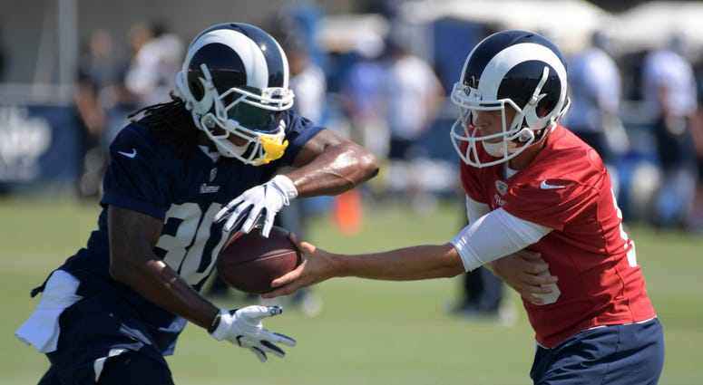 Los Angeles Rams quarterback Jared Goff (16) hands the ball off to running back Todd Gurley (30) during training camp at UC Irvine. NFL: Los Angeles Rams-Training Camp