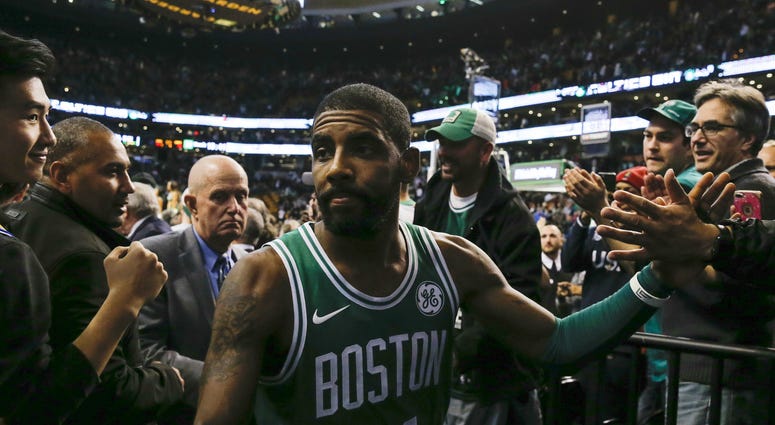 Boston Celtics guard Kyrie Irving (11) celebrates with fans while leaving the court after defeating the Golden State Warriors 92-88 at TD Garden. NBA: Golden State Warriors at Boston Celtics
