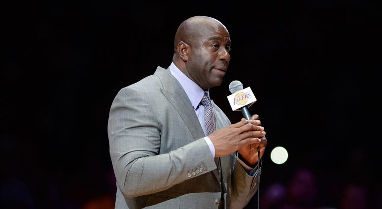 Los Angeles Lakers former player Magic Johnson introduces Lakers forward Kobe Bryant (not pictured) before a game against the Utah Jazz at Staples Center. Bryant concludes his 20-year NBA career tonight. NBA: Utah Jazz at Los Angeles Lakers
