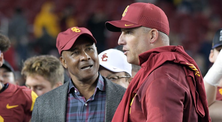 Southern California Trojans athletic director Lynn Swann (left) talks with head coach Clay Helton after the Pac-12 Conference championship game against the Stanford Cardinal at Levi's Stadium Southern California Trojans athletic director Lynn Swann (left) talks with head coach Clay Helton after the Pac-12 Conference championship game against the Stanford Cardinal at Levi's Stadium