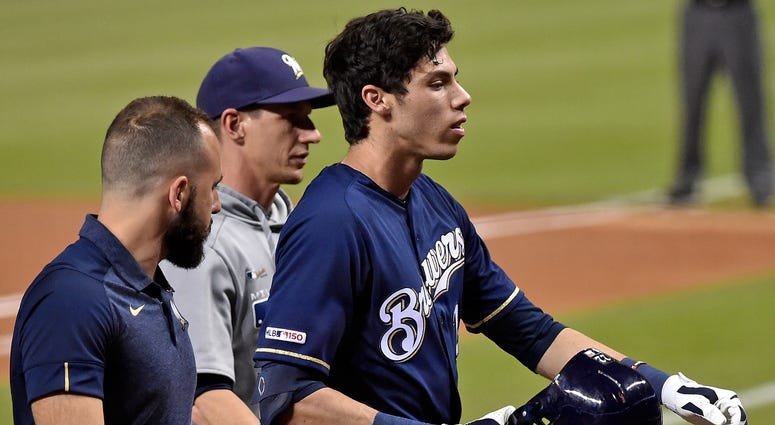 Milwaukee Brewers right fielder Christian Yelich (22) leaves the game after suffering an apparent injury in the first inning against the Miami Marlins at Marlins Park Milwaukee Brewers right fielder Christian Yelich (22) leaves the game after suffering an apparent injury in the first inning against the Miami Marlins at Marlins Park
