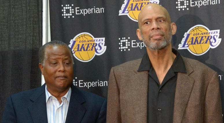 Magic Johnson (right) speaks at a press conference to introduce Byron Scott (center) as Los Angeles Lakers coach as Jamaal Wilkes (left) and Kareem Abdul-Jabbar (second from left) listen at Toyota Sports Center. NBA: Los Angeles Lakers-Byron Scott Press Conference