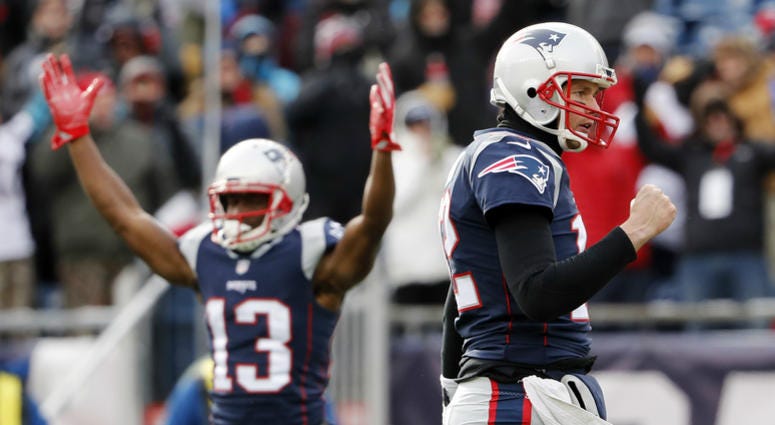 New England Patriots quarterback Tom Brady (12) and wide receiver Phillip Dorsett (13) celebrate a touchdown against the New York Jets during the first quarter at Gillette Stadium. NFL: New York Jets at New England Patriots