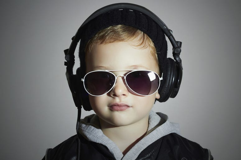 Kid listens to headphones Kid listens to headphones