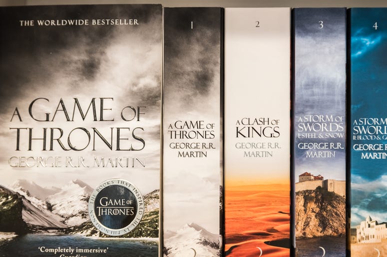 BUCHAREST, ROMANIA - MARCH 07, 2015: Game Of Thrones Books For Sale On Library Shelf. It is the first novel in a series of high fantasy novels by American author George R. R. Martin. BUCHAREST, ROMANIA - MARCH 07, 2015: Game Of Thrones Books For Sale On Library Shelf. It is the first novel in a series of high fantasy novels by American author George R. R. Martin.