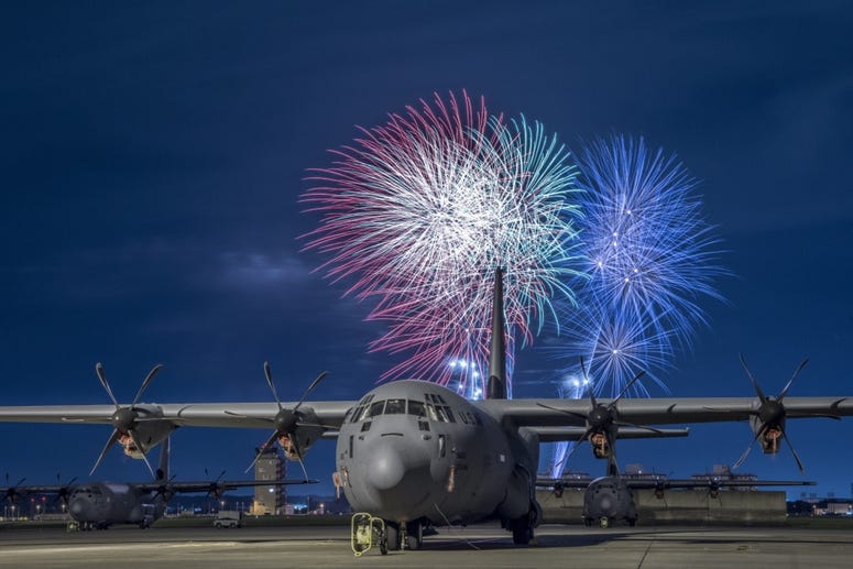 A C-130J Super Hercules rests on the flightline under a fireworks display, July 3, 2018, at Yokota Air Base, Japan. Fireworks