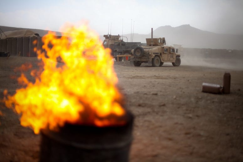 The flames of a burn pit picks up with the winds as a storm approaches Combat Outpost Tangi in the Tangi Valley, Afghanistan, Aug. 31, 2009. BurnPits5